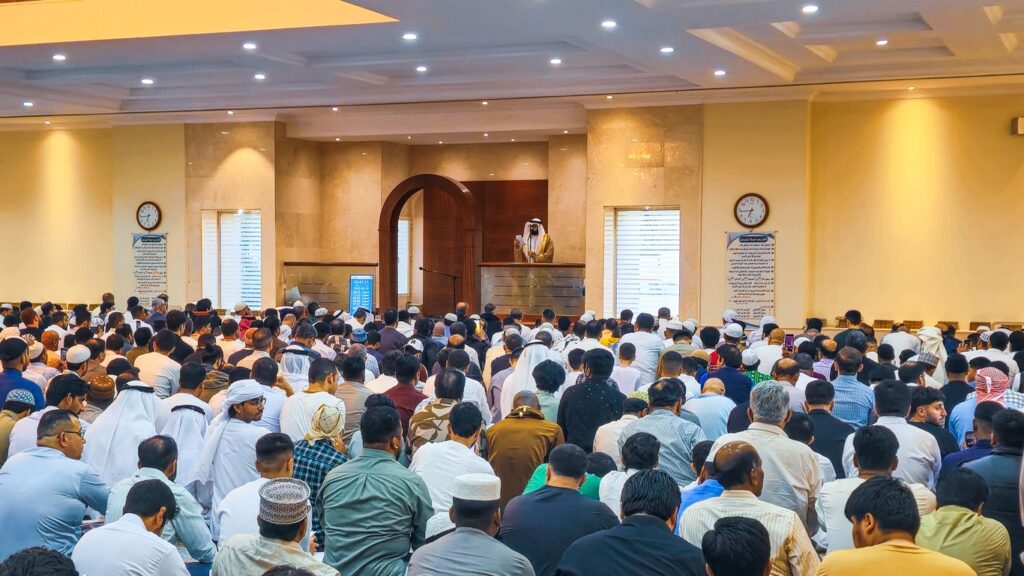 People praying together inside of a mosque.
